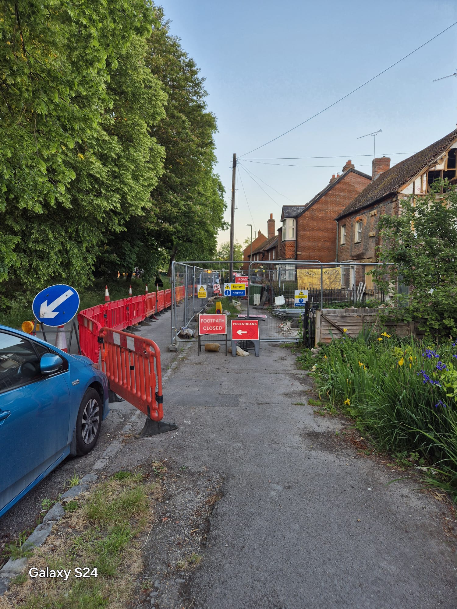 Footpath closed and pedestrians arrow signage diverting people around a village works site