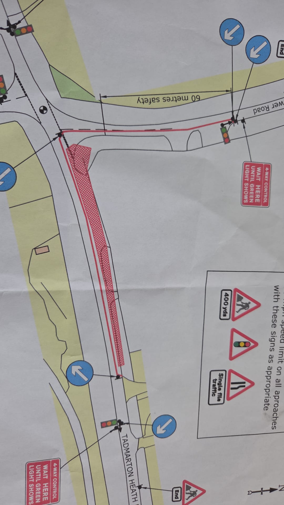 Four-way temporary traffic signal design drawing with wait here until green light shows signage and safety zone dimensions